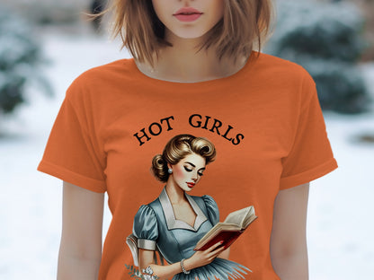 Orange t-shirt with "HOT GIRLS" and retro illustration of woman reading.
