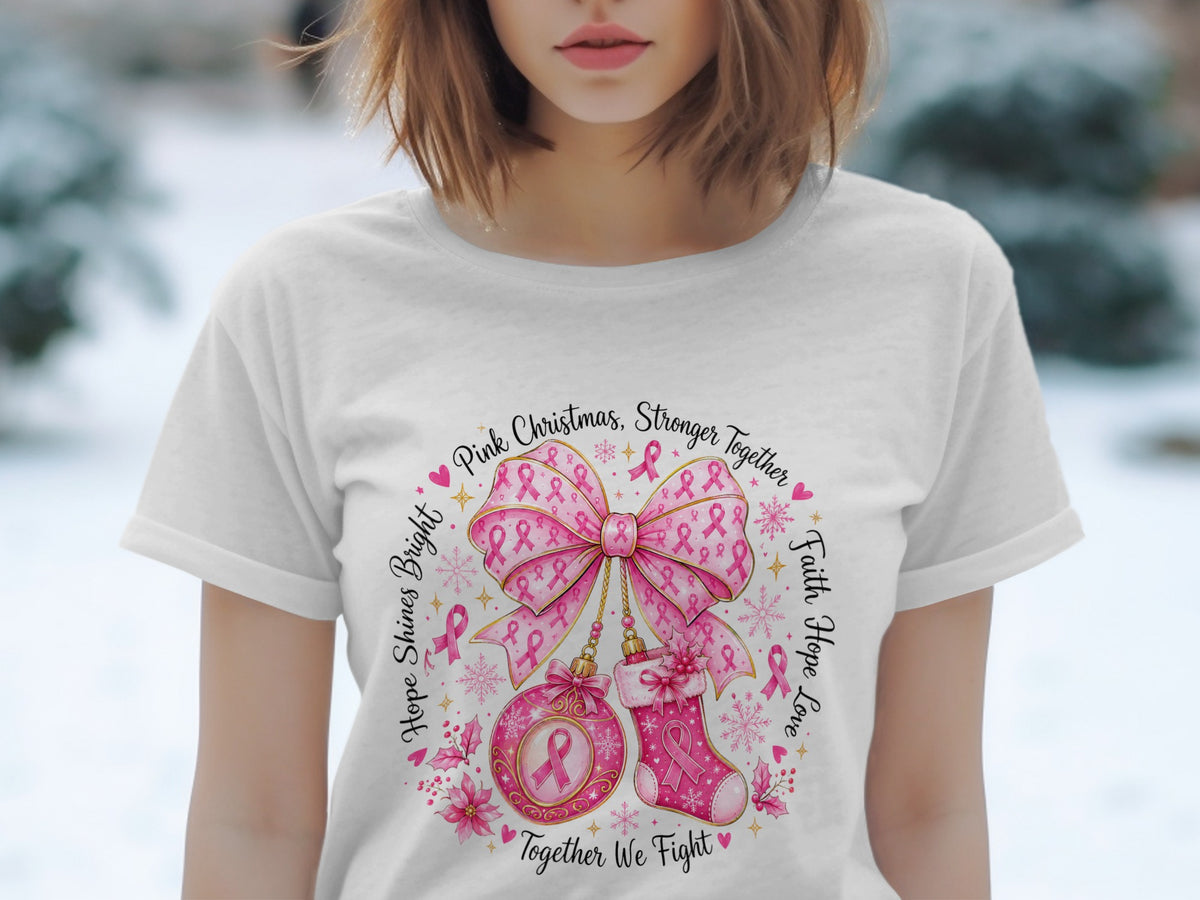 White t-shirt with "Pink Christmas, Stronger Together" graphic featuring pink ribbons, a bow, ornament, and stocking.