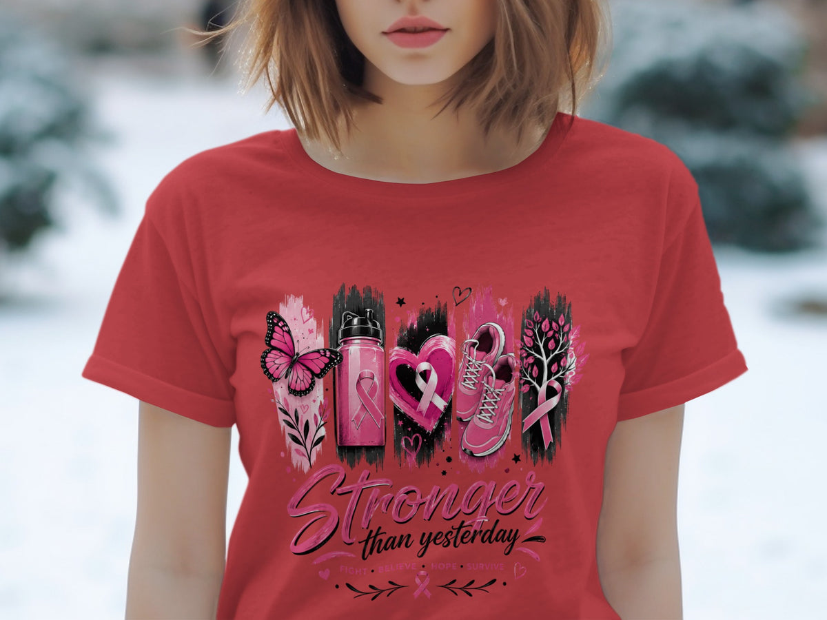 Red t-shirt with "Stronger than yesterday" text and breast cancer awareness symbols.