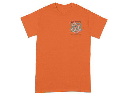 Orange t-shirt with "CREATE YOUR OWN MAGIC WALK YOUR OWN PATH" text and mushroom graphic.