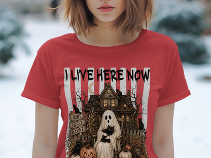Ghost in rocking chair with cat, haunted house, pumpkins, and "I Live Here Now" text.