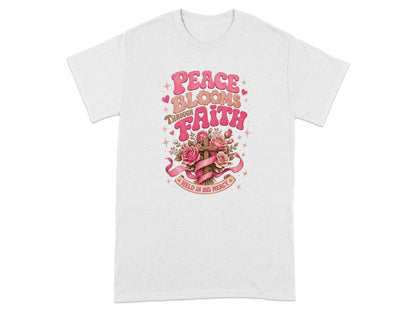 T-shirt with "Peace Blooms Through Faith Held in His Mercy" text and floral cross graphic.