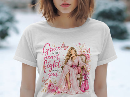 T-shirt with watercolor art of a woman sitting with boxing gloves and text "Grace in her heart, fight in her soul."