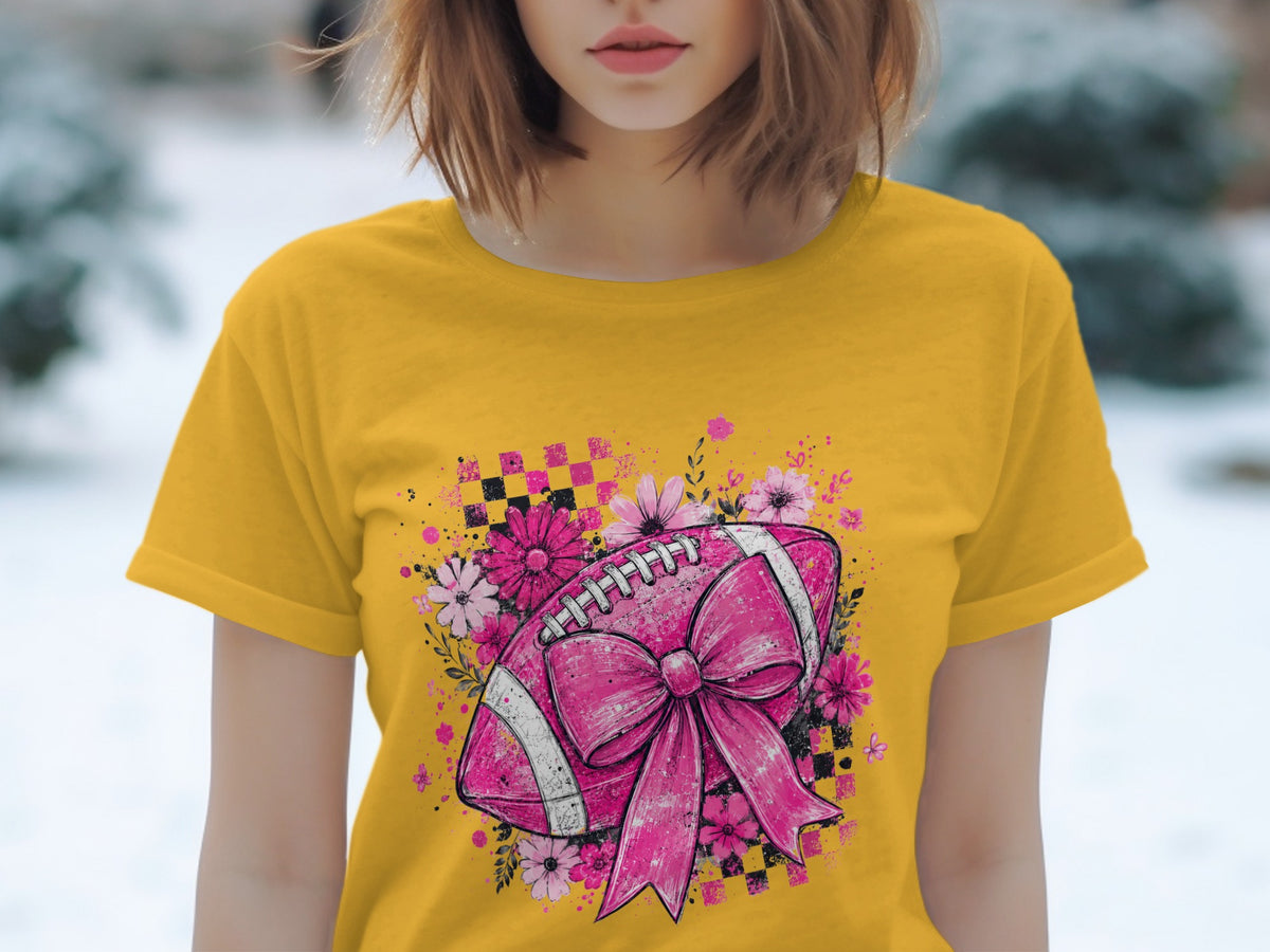 Yellow t-shirt with pink football and flowers graphic.
