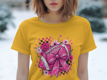 Yellow t-shirt with pink football and flowers graphic.