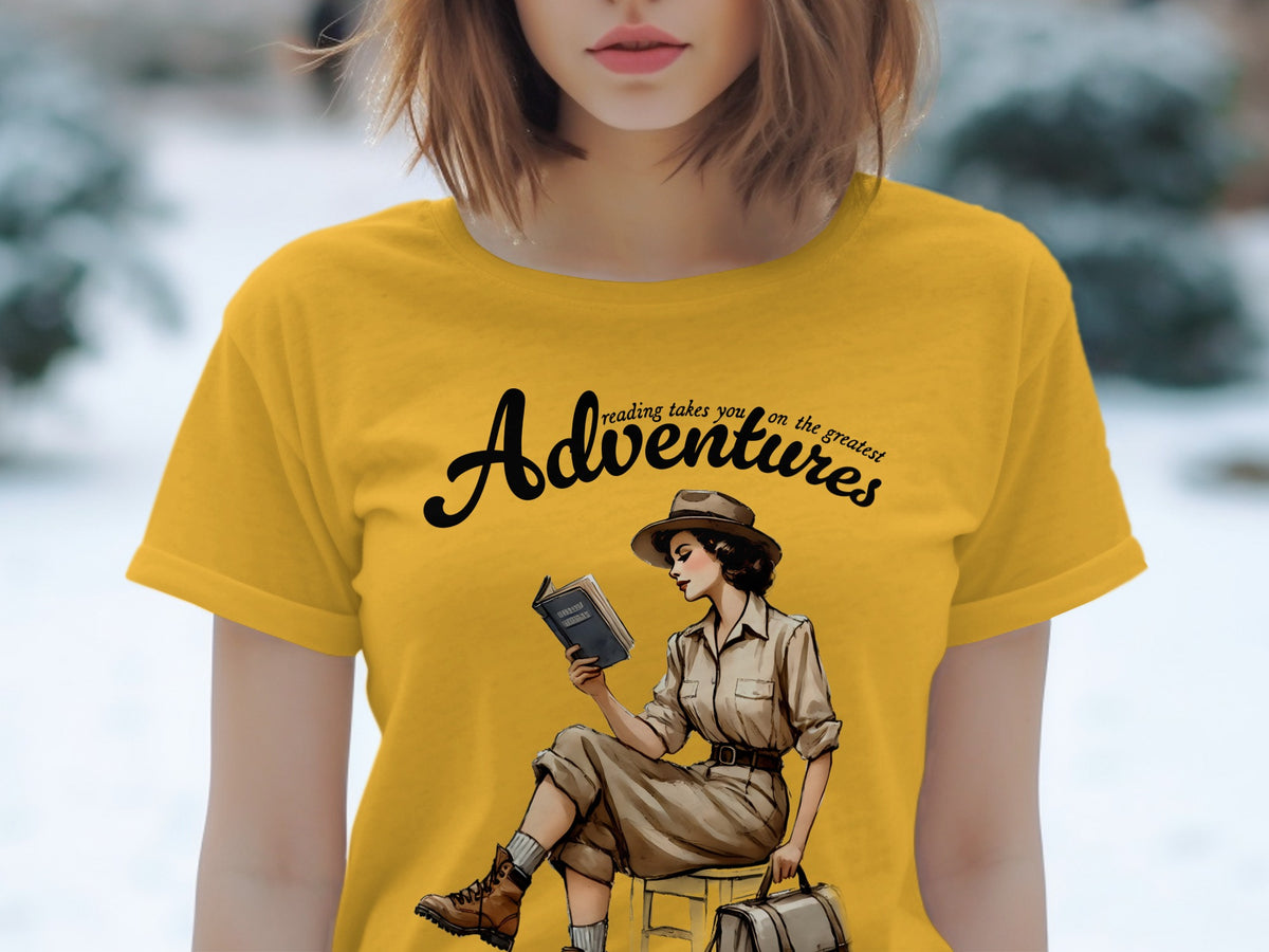 Yellow t-shirt with "Adventures reading takes you on the greatest" text and vintage explorer reading a book.
