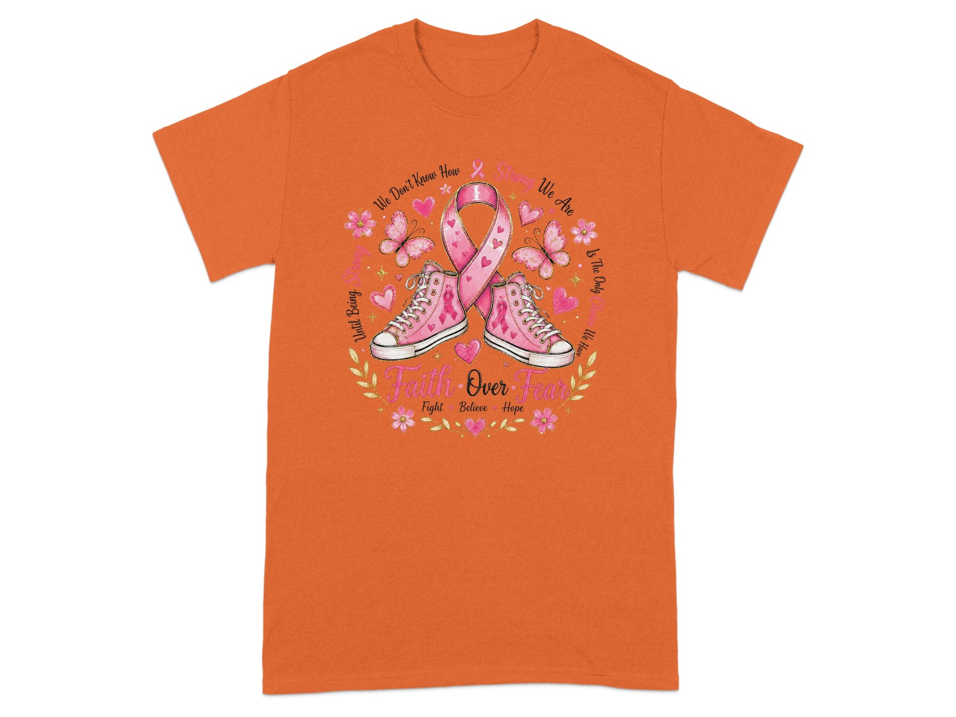 Pink ribbon, sneakers, butterflies, and "Faith Over Fear" text on an orange t-shirt.