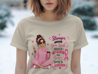 Illustration of woman with coffee cup, breast cancer ribbon, and text: Stronger than you think, braver than you feel, never giving up.