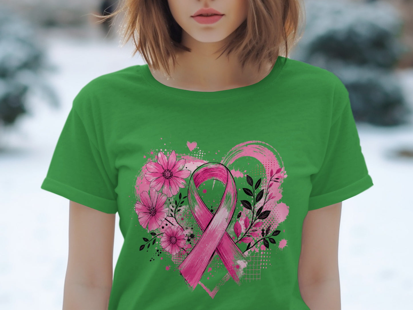 Green t-shirt with pink ribbon and floral heart design for breast cancer awareness.