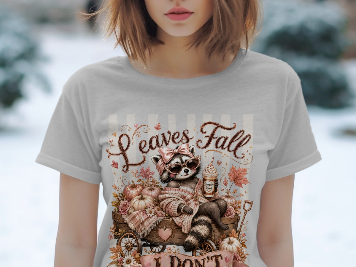 Raccoon in wagon with pumpkins and autumn leaves, "Leaves Fall" text.