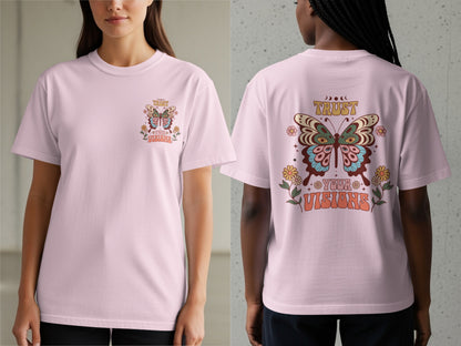 Pink t-shirt with butterfly graphic and text "Trust Your Visions" on back.