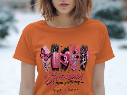 Orange t-shirt with pink butterfly, water bottle, heart, shoes, and tree graphics.