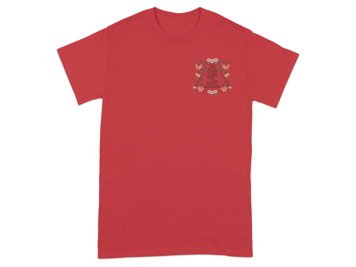 Red t-shirt with a floral graphic and the text "You gotta keep going to keep growing".
