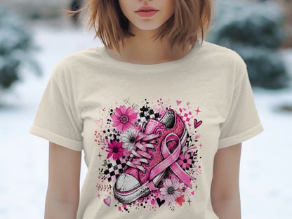 Pink sneaker with breast cancer ribbon surrounded by flowers and hearts.