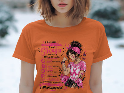 Orange t-shirt with "I Am Stronger Than What Cancer Tried to Take" and warrior illustration.