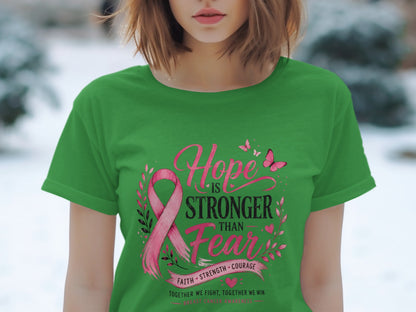 Green t-shirt with pink breast cancer ribbon and "Hope is Stronger Than Fear" text.