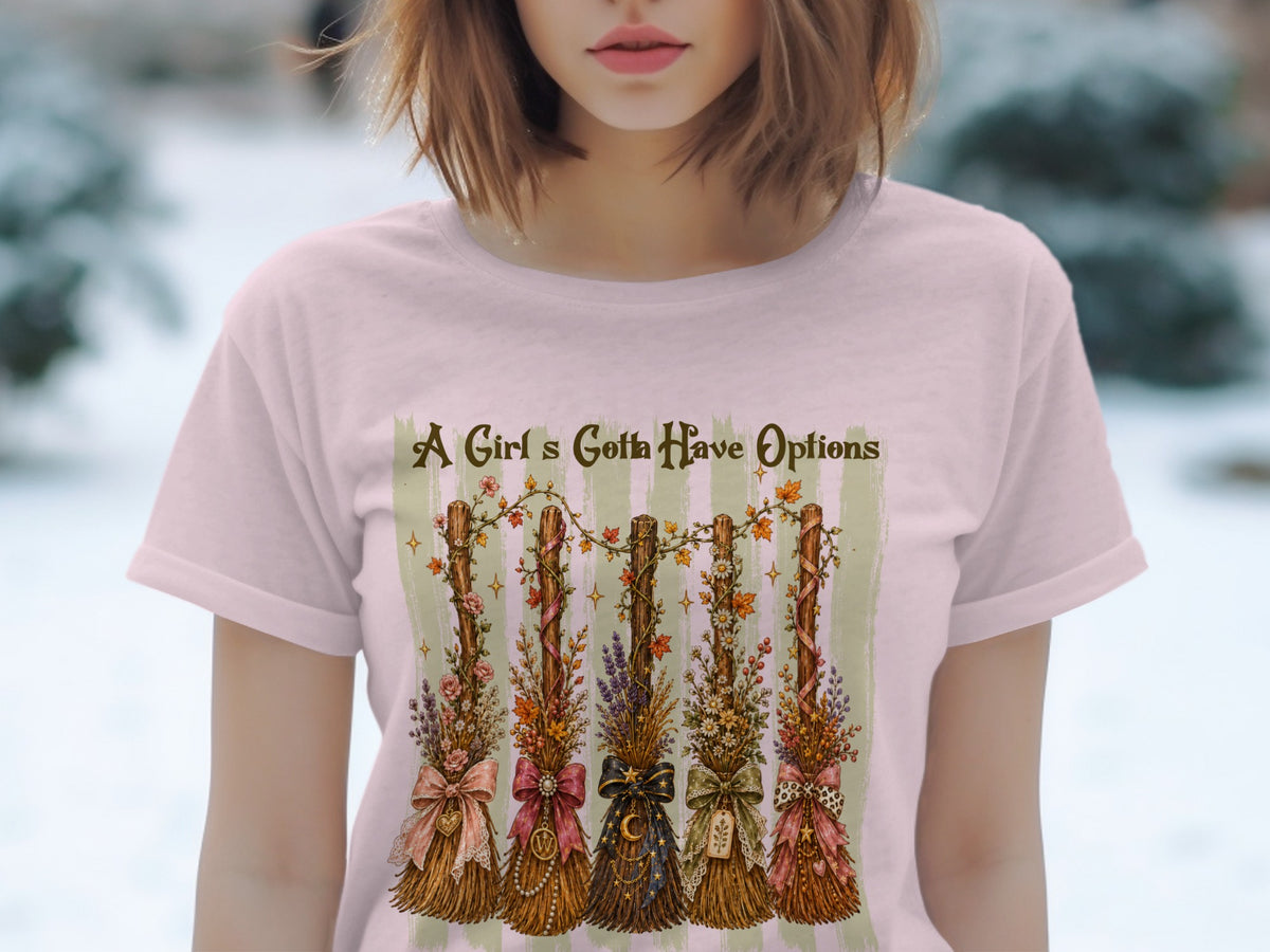 A Girl's Gotta Have Options graphic with five decorative brooms on pink t-shirt.