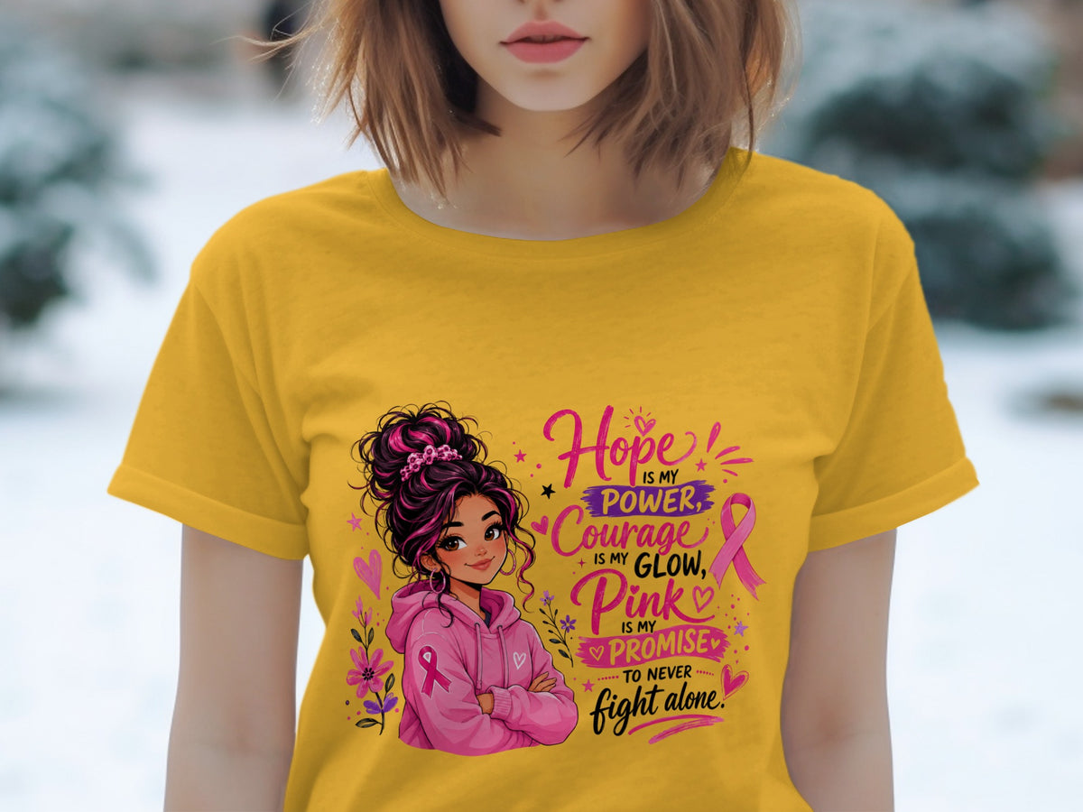 Yellow t-shirt with illustration and text about hope, courage, and pink.