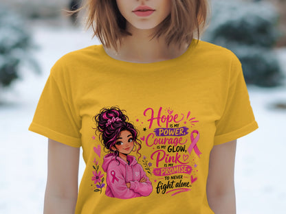 Yellow t-shirt with illustration and text about hope, courage, and pink.