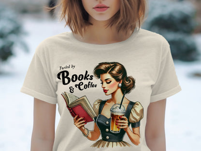T-shirt graphic: woman reading book, holding coffee, text "Fueled by Books & Coffee".