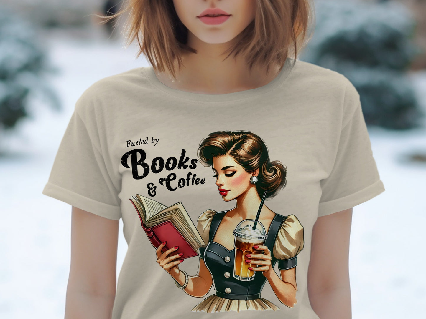 T-shirt graphic: woman reading book, holding iced coffee, with text "Fueled by Books & Coffee".