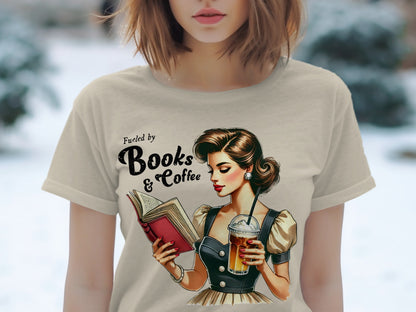 T-shirt graphic: woman reading book, holding iced coffee, with text "Fueled by Books & Coffee".