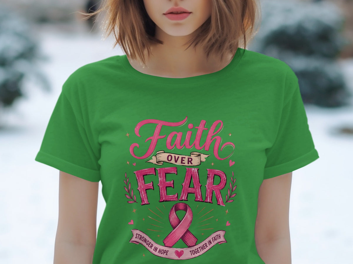 Green t-shirt with pink text that reads "Faith Over Fear" and a pink ribbon.