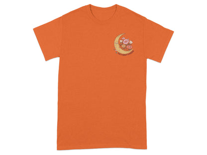 Orange t-shirt with a crescent moon, flowers, and text reading "TAKE A MOMENT TO BREATHE".