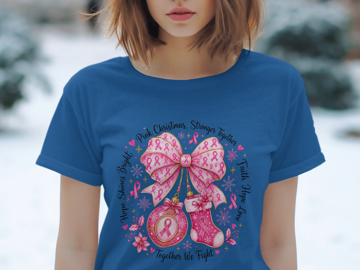 Blue t-shirt with pink Christmas design featuring a bow, ornament, stocking, and text.
