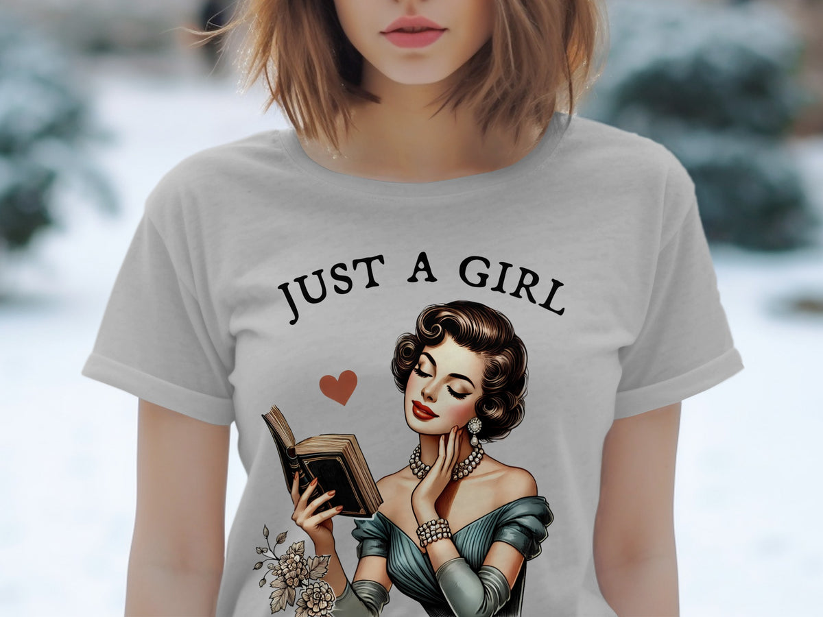 Grey t-shirt with "JUST A GIRL" and vintage illustration of woman reading.