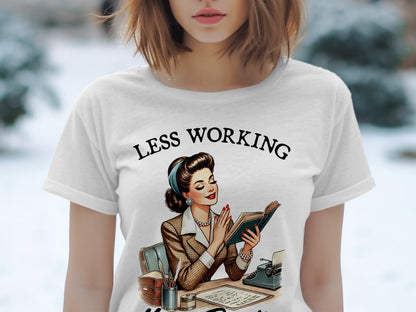 T-shirt with illustration of woman reading a book with text "LESS WORKING".
