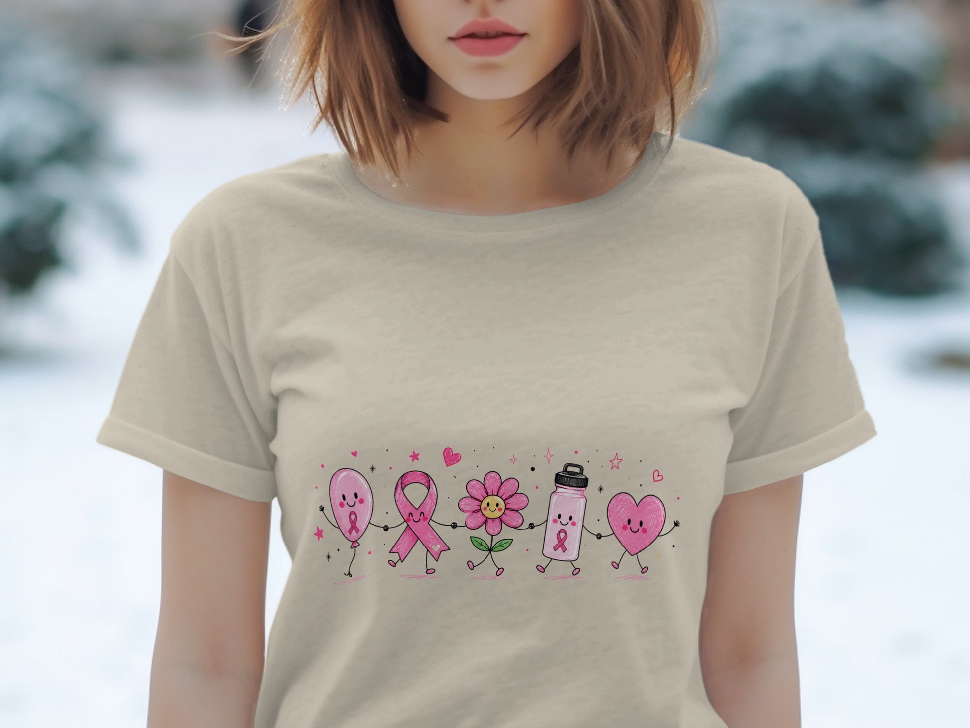Pink balloon, ribbon, flower, water bottle, and heart graphic on a light beige t-shirt.