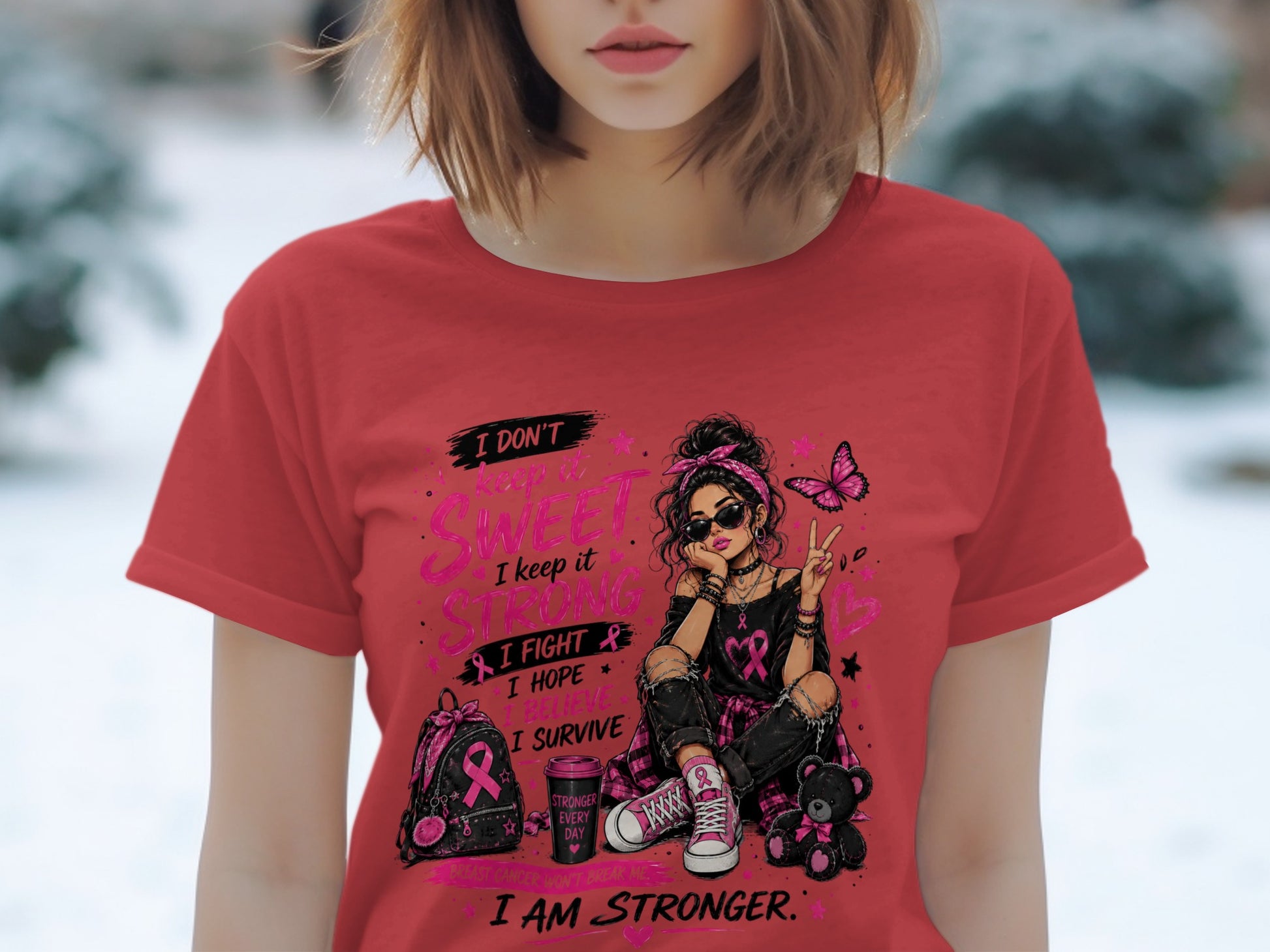 T-shirt graphic with a woman, butterfly, and pink ribbon text about strength and survival.