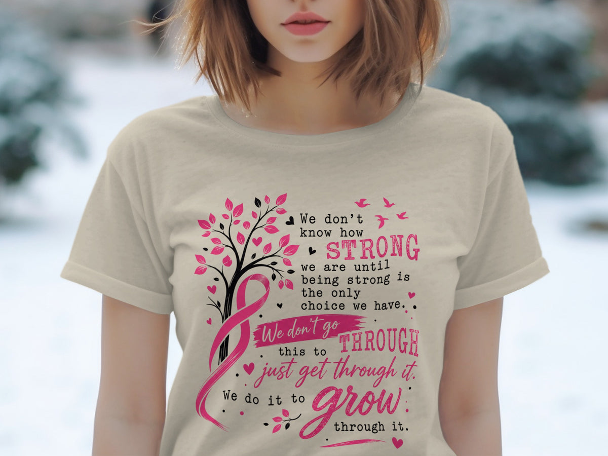 Light tan t-shirt with pink breast cancer ribbon, tree, birds, and text.