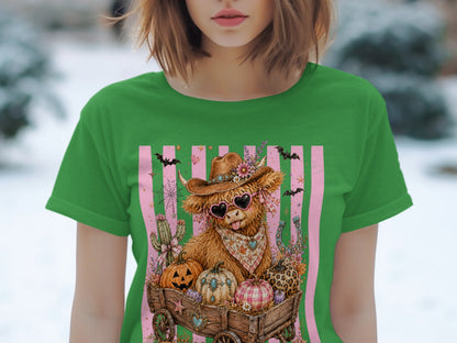 Highland cow in cowboy hat and heart sunglasses in wagon with pumpkins and bats.