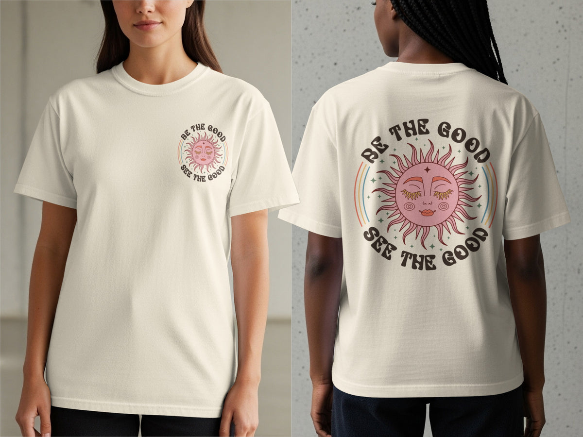 Cream t-shirt with a graphic of a sun and rainbows with text "Be the Good See the Good".
