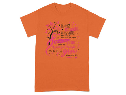 Orange t-shirt with pink tree, ribbon, and text about strength and growth.
