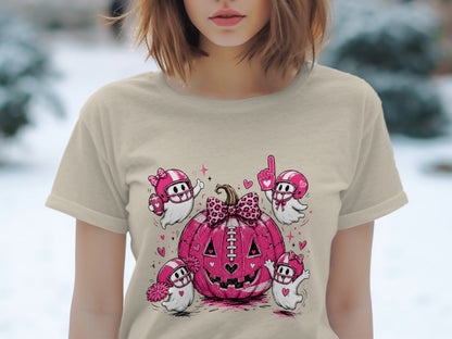 Pink football pumpkin with four cartoon ghosts in helmets and heart designs.