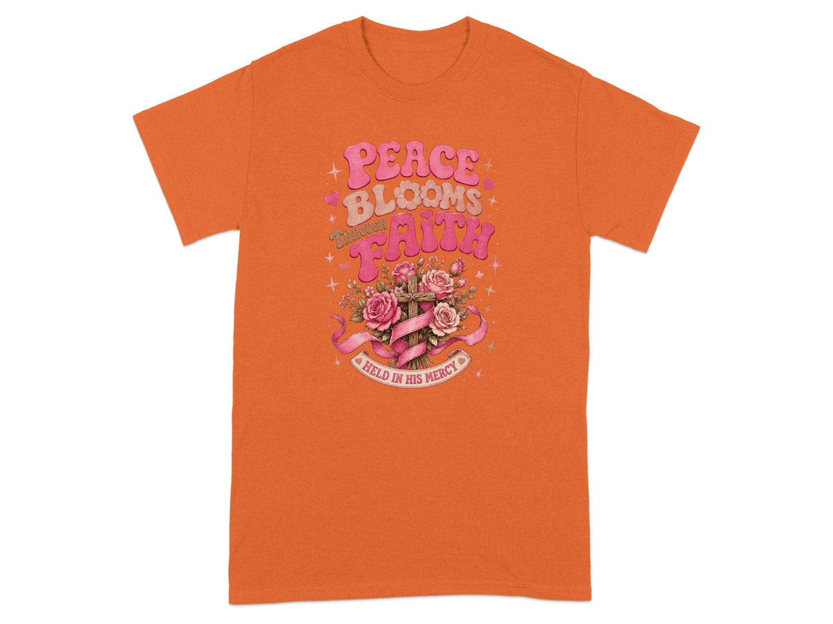 Orange t-shirt with "Peace Blooms Through Faith" and a cross with roses.