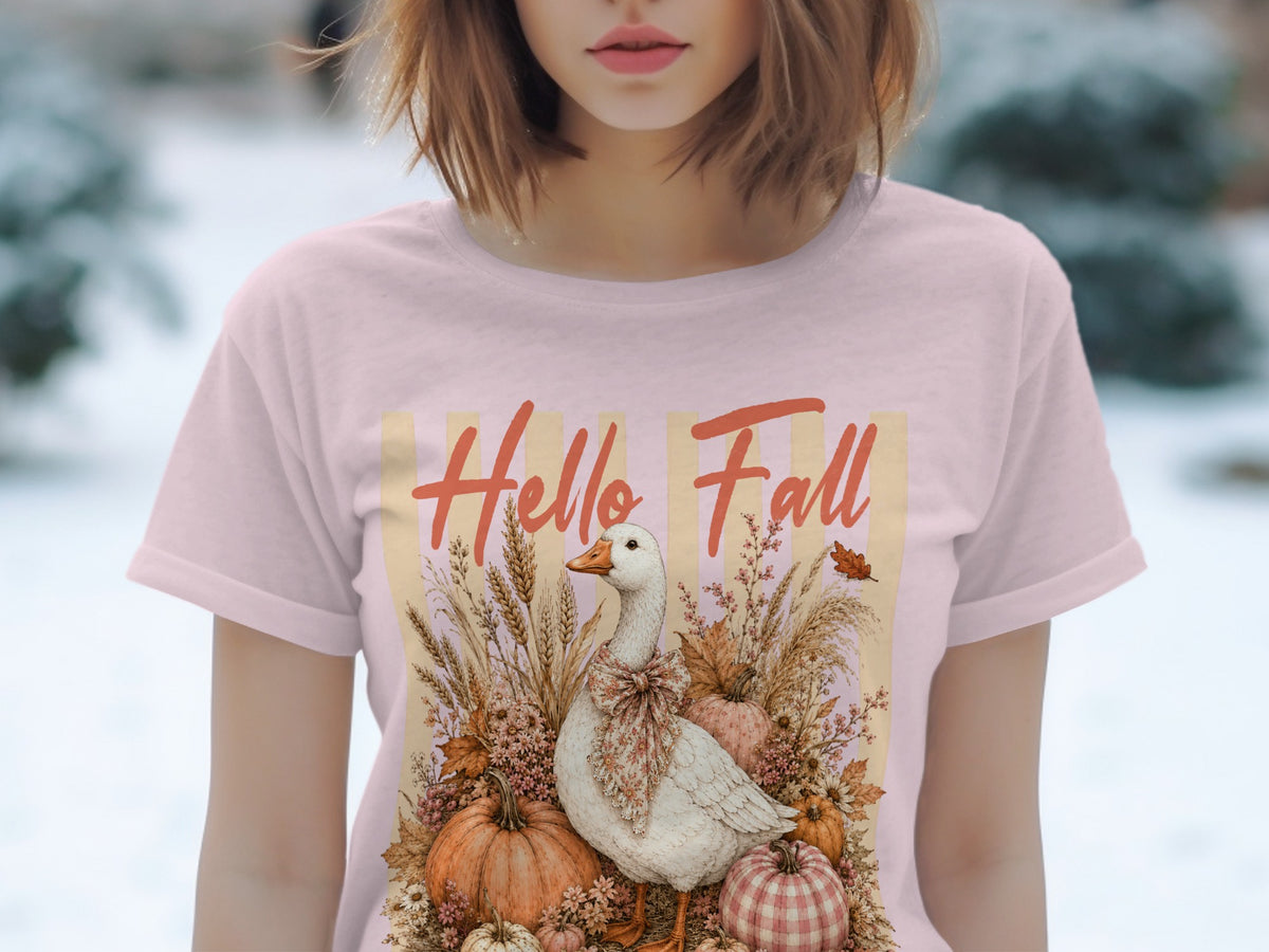 Pink t-shirt with a goose, pumpkins, and "Hello Fall" text graphic.