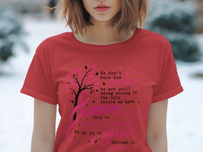 Red t-shirt with a pink tree and ribbon design and text about strength.