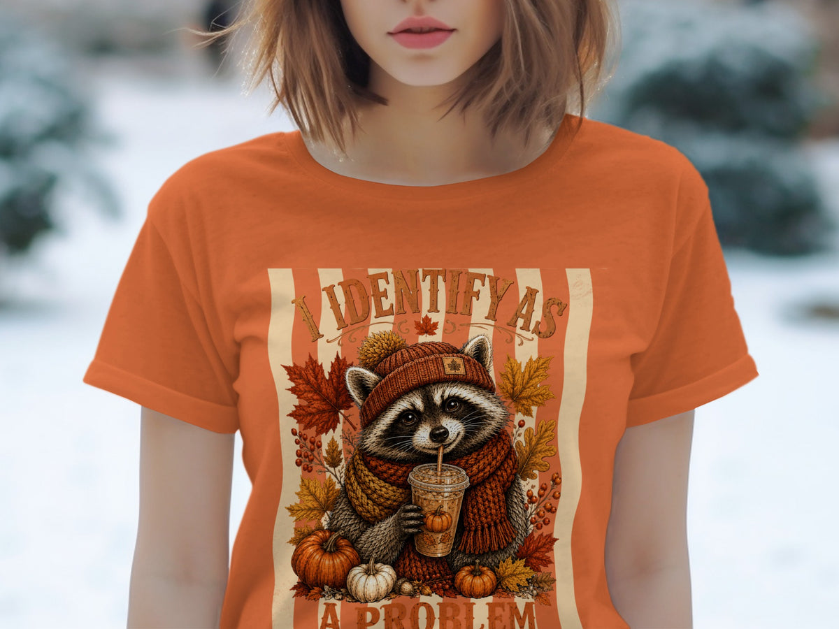Raccoon with pumpkin spice latte and autumn leaves, text "I IDENTIFY AS A PROBLEM".