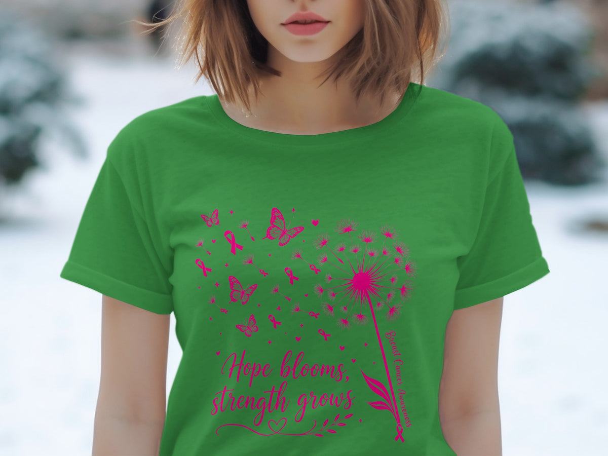 Green t-shirt with pink dandelion, butterflies, ribbons, and text "Hope blooms, strength grows".