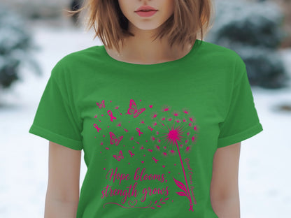 Green t-shirt with pink dandelion, butterflies, ribbons, and text "Hope blooms, strength grows".