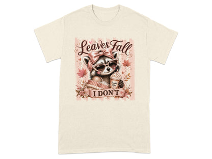 Raccoon in sunglasses with a bow, holding a pumpkin mood drink, "Leaves Fall I Don't" text.