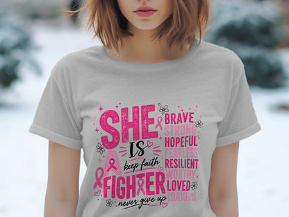 Light grey t-shirt with pink text "She is a fighter" and empowering words.