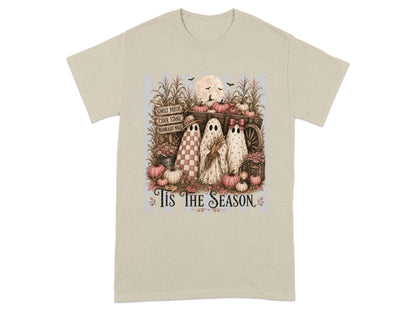 Three ghosts stand by a wagon of pumpkins with corn stalks and the text "Tis The Season".
