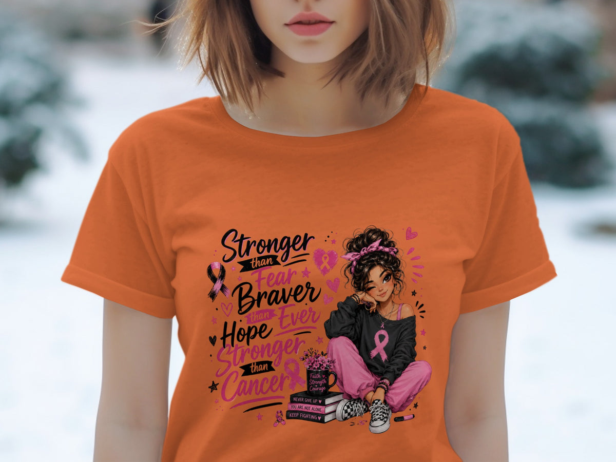 Orange t-shirt with graphic of a woman and inspirational text about cancer awareness.