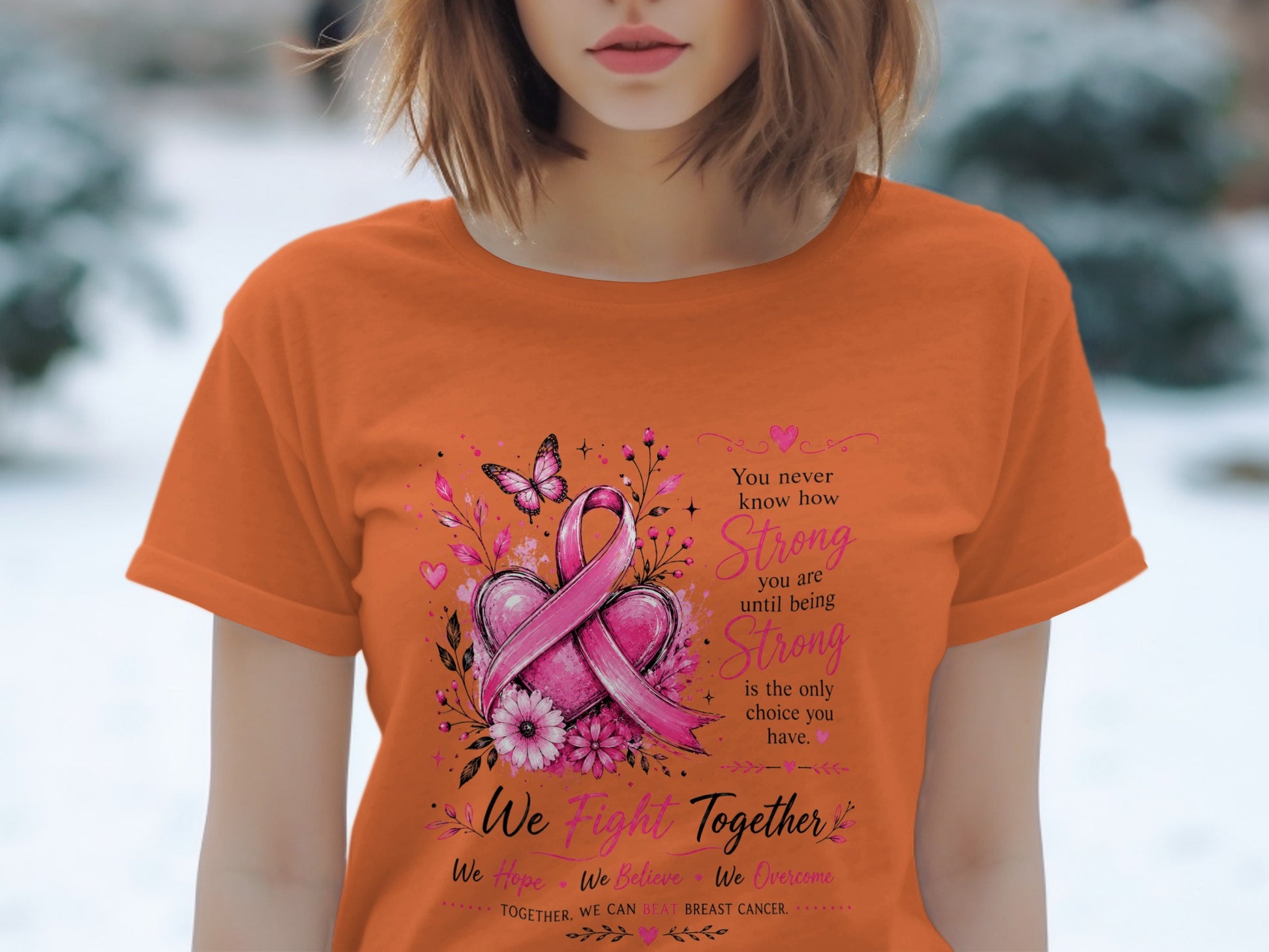 Orange t-shirt with breast cancer ribbon, hearts, flowers, butterfly, and text.