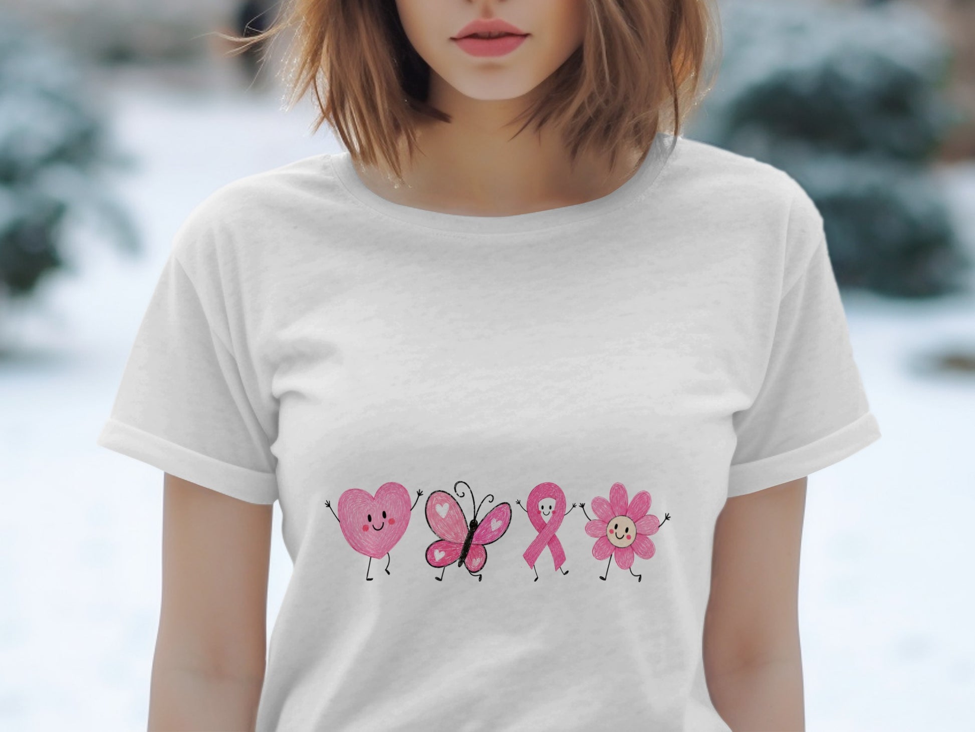 White t-shirt with pink cartoon heart, butterfly, ribbon, and flower characters.